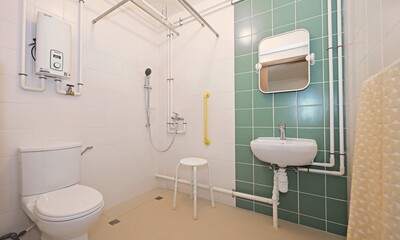 The unit has integrated various age-friendly features, such as an accessible toilet and a bathroom with low door curb, sliding door, handrails, a non-slip shower chair and an adjustable tilt mirror, catering to the needs of wheelchair users.